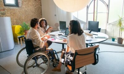 A diverse group of coworkers collaborating in an accessible office environment with a focus on inclusivity.