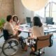 A diverse group of coworkers collaborating in an accessible office environment with a focus on inclusivity.